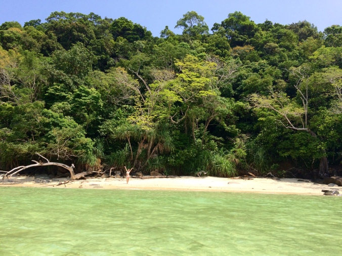 Alexis poses on a secluded and jungle-lined beach on the south side of Sapi island